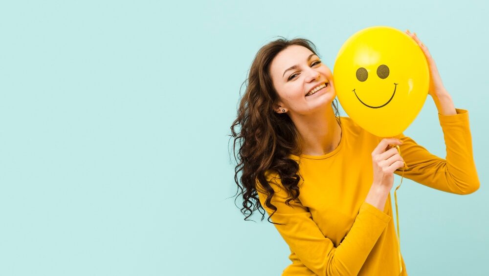 Image of a smiling person for a blog post about the ways to be happy.