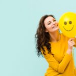 Image of a smiling person for a blog post about the ways to be happy.