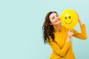 Image of a smiling person for a blog post about the ways to be happy.